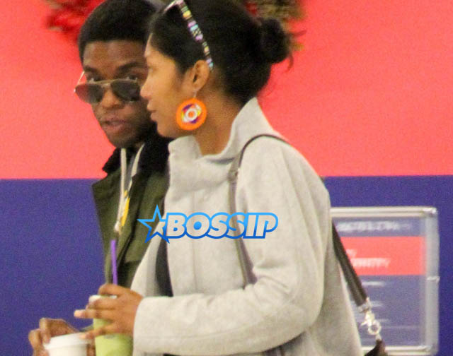 AKM GSI Chadwick Boseman female friend arrive at LAX
