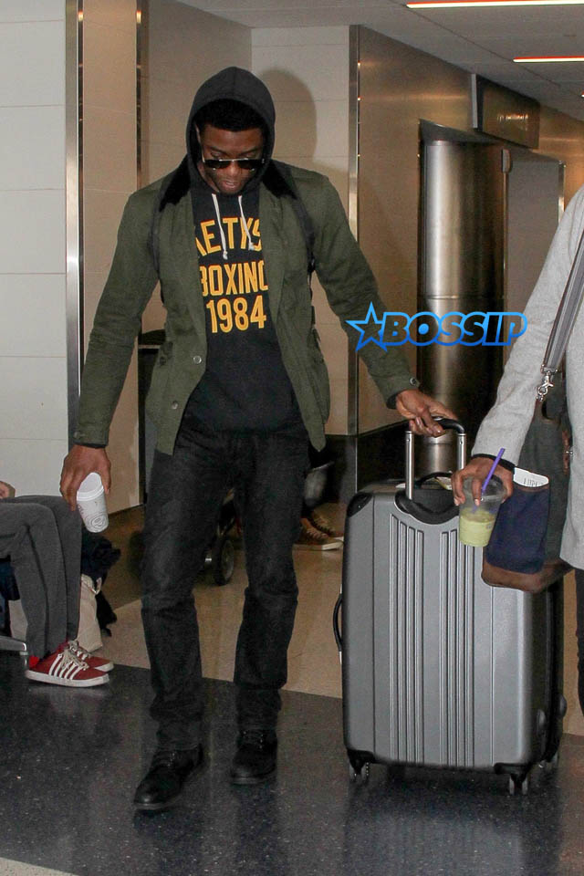 AKM GSI Chadwick Boseman female friend arrive at LAX