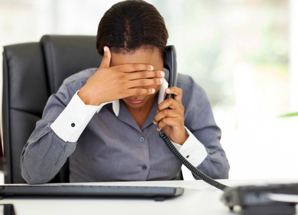 black woman on phone frustrated