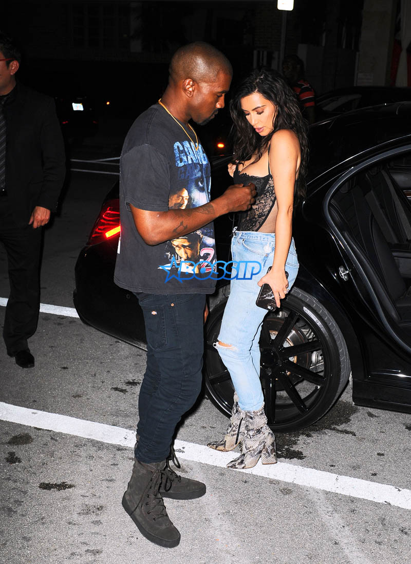 Kim Kardashian Kanye West Prime One Twelve dinner in Miami SplashNews black lacy corset top wardrobe malfunction tupac gang related tee shirt