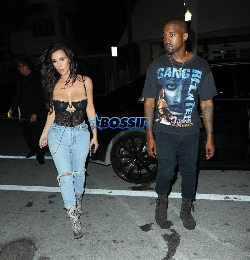 Kim Kardashian Kanye West Prime One Twelve dinner in Miami SplashNews black lacy corset top wardrobe malfunction tupac gang related tee shirt