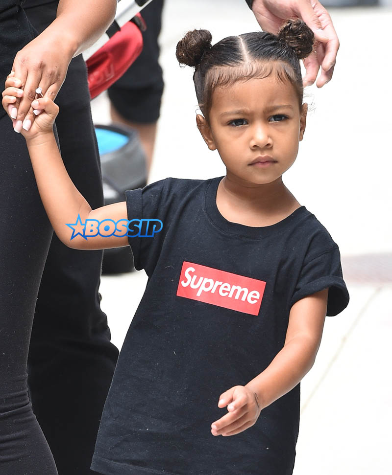 North West, Supreme t-shirt hair in knots, Kim Kardashian's apartment  nanny in New York City SplashNews Leezy Boosts Kanye West face