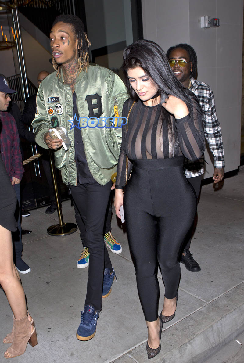 SplashNews Wiz Khalifa dinner 'Catch' in West Hollywood bag kush and a gold tin grinder. woman black catsuit brunette sheer nipple covers