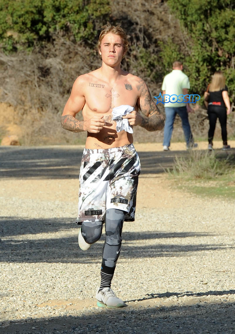 Justin Bieber shirtless run in Los Angeles. pop singer tattoos workout WENN