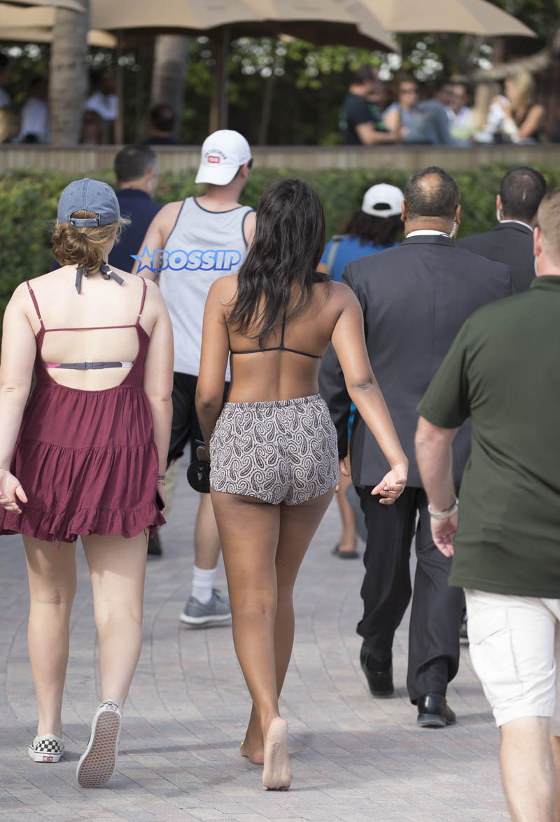 Sasha Obama beach in Miami President Obama's 15-year-old daughter Saturday afternoon. surrounded by secret service agents in plain clothes and hotel security. black bikini top print shorts white off the shoulder top SplashNews