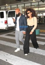Solange Knowles husband, Alan Ferguson at LAX with highwater pants, camel-toe shoes and a beige top. SplashNews beard denim jacket white sneakers holding hands