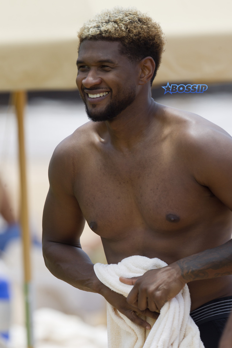 Usher and friends paddle boarding in Maui SplashNews