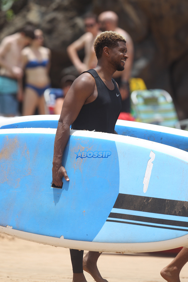 Usher and friends paddle boarding in Maui SplashNews