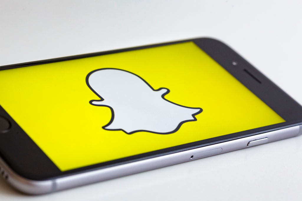 BERLIN, GERMANY - MAY 04: In this photo illustration the logo of Snapchat is displayed on a smartphone on May 04, 2017 in Berlin, Germany.
