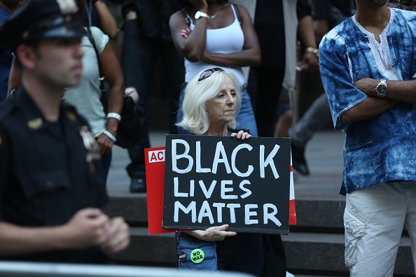 NEW YORK, USA - AUGUST 23 : A woman holds a banner reading "Black Lives Matter" during a rally against the National Football League (NFL), supporting Colin Kaepernick in Manhattan borough of New York, United States on August 23, 2017.