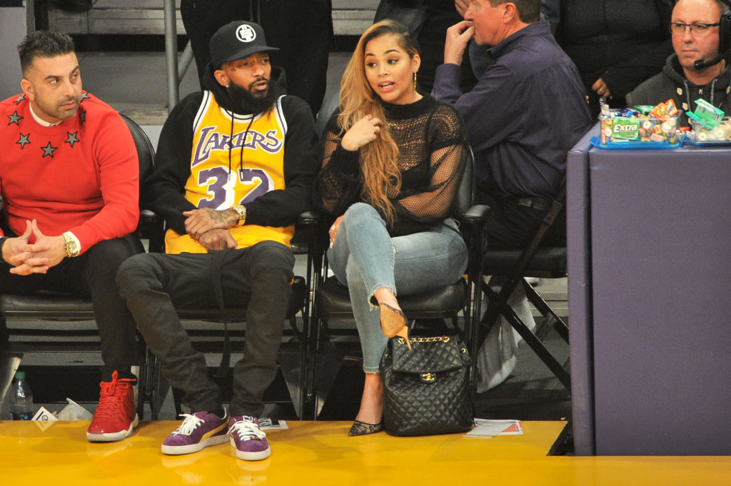 LOS ANGELES, CA - DECEMBER 25: Rapper Nipsey Hussle and Lauren London attend a basketball game between the Los Angeles Lakers and the Minnesota Timberwolves at Staples Center on December 25, 2017 in Los Angeles, California.