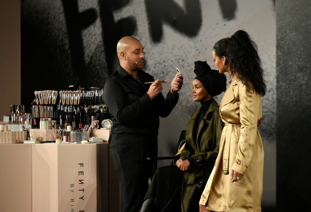 DUBAI, UNITED ARAB EMIRATES - SEPTEMBER 29: Hector Espinal, Rihanna, and Halima on stage during the Fenty Beauty Artistry and Beauty talk with Rihanna in collaboration with Sephora, for the launch of her new Stunna Lip paint "Uninvited" on September 29, 2018 in Dubai, United Arab Emirates.