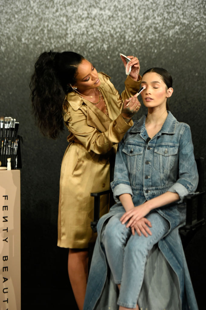 DUBAI, UNITED ARAB EMIRATES - SEPTEMBER 29: Rihanna applies make up on a model during her Fenty Beauty talk in collaboration with Sephora, for the launch of her new Stunna Lip paint "Uninvited" on September 29, 2018 in Dubai, United Arab Emirates.