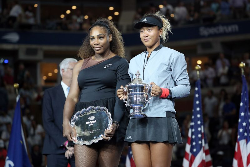 Tennis players Naomi Osaka and Serena Williams hold their respective trophies during the trophy presentation ceremony for the Women's singes title at the 2018 U.S. Open in New York, NY.