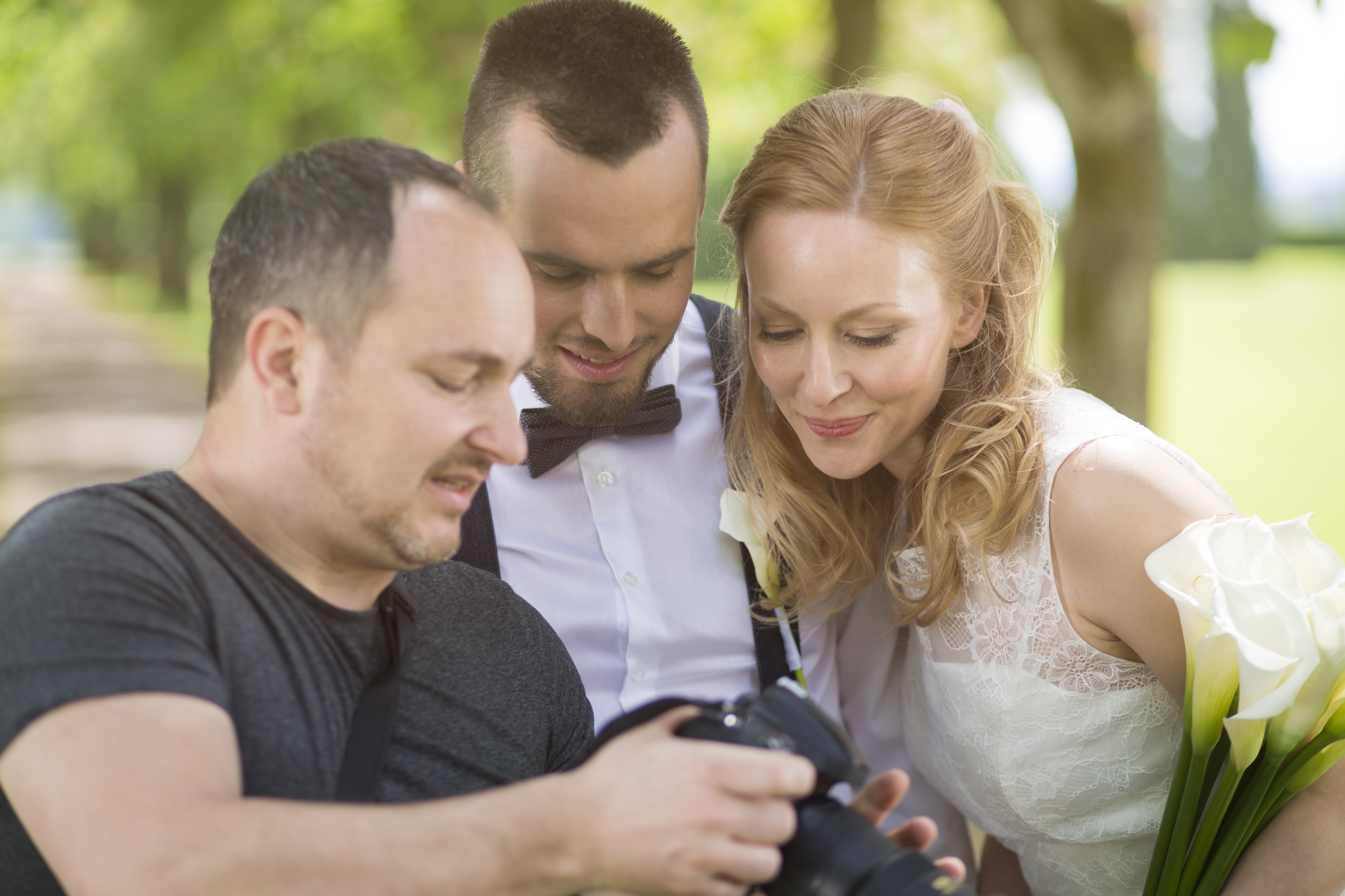 Wedding photographer showing the photos to the couple