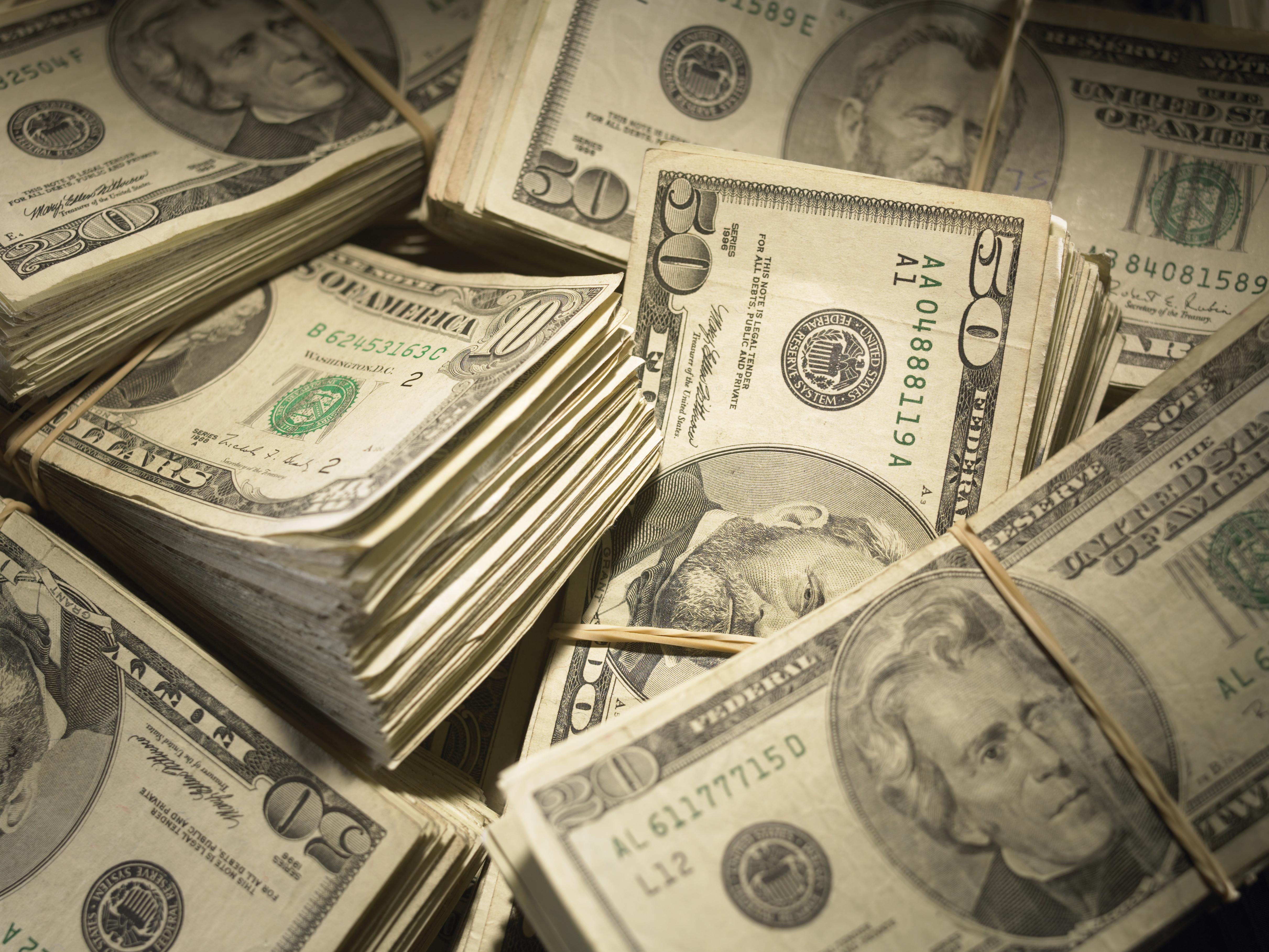 US Currency: Wads of US bills fastened with rubber bands, close-up