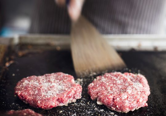 Beefburgers being flipped