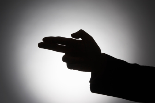 Silhouette human finger making pistol gun sign
