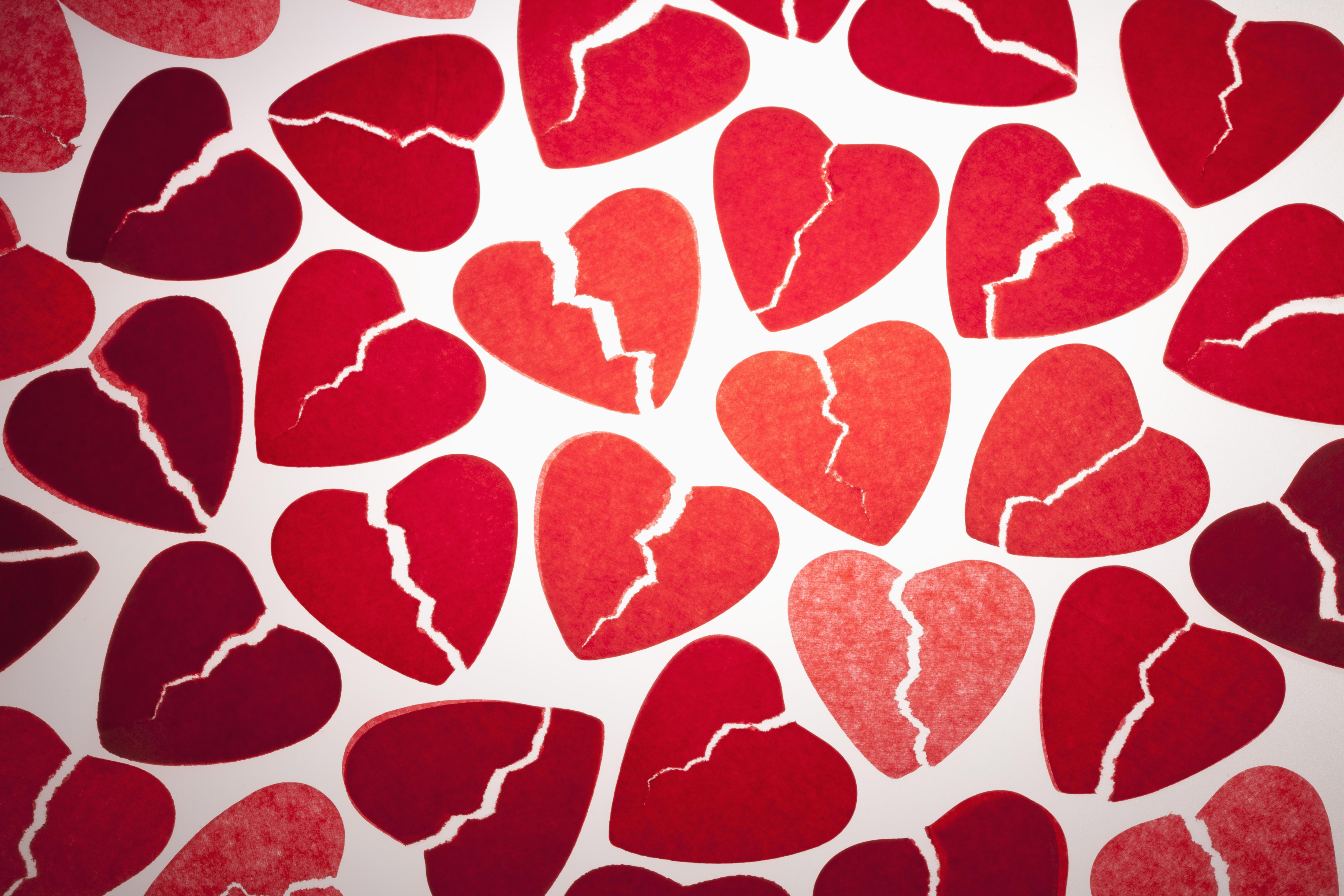 A bunch of red tissue paper broken hearts