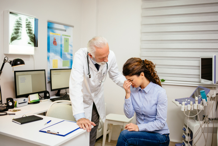 Doctor comforting a patient with health issues