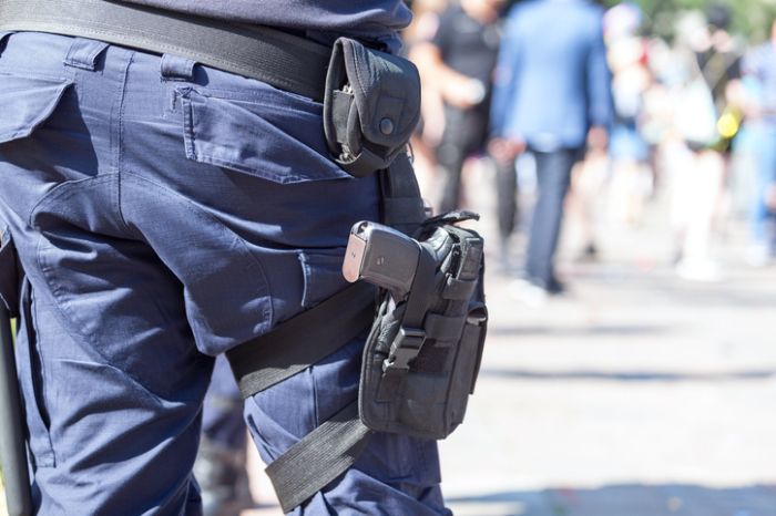 Midsection Of Police Standing On Street