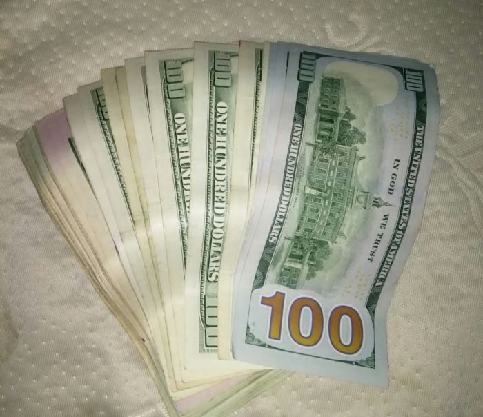 Close-Up Of Stack Of One Hundred Dollars