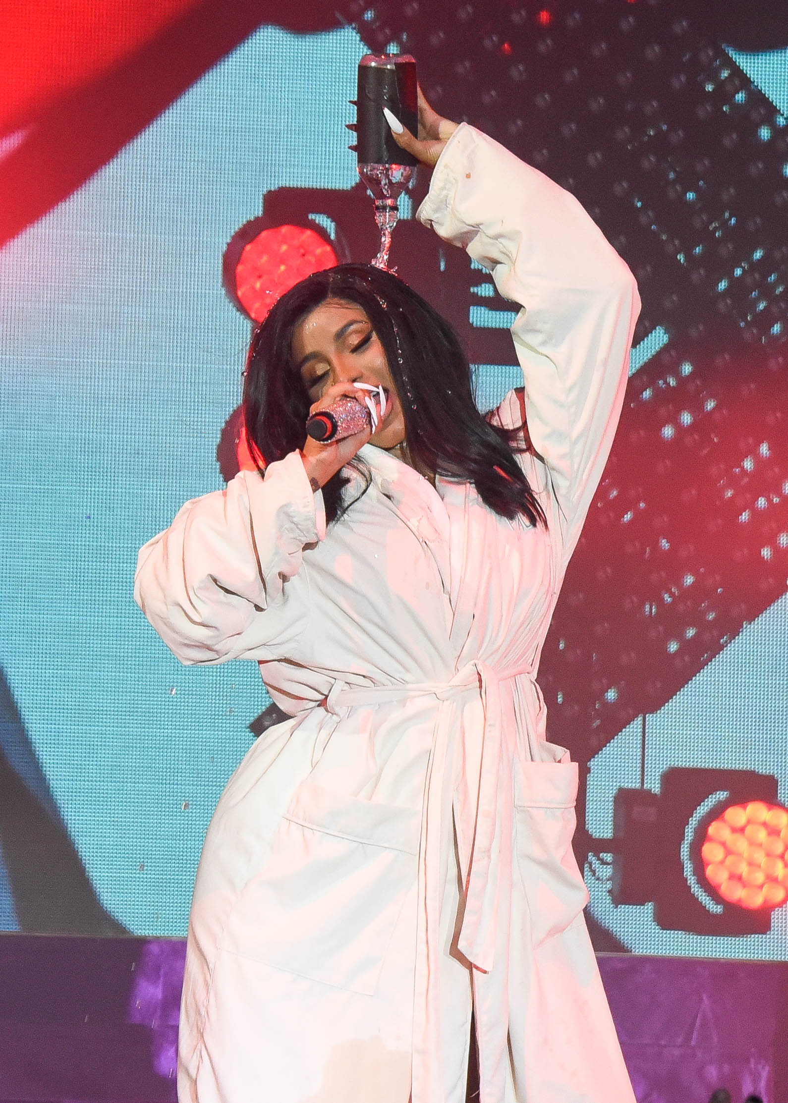 Cardi B Performs in a Bathrobe at Bonaroo after Busting Open Dior Sequined jumpsuit