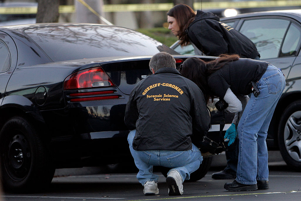 Orange County forensic investigators look for finger prints on a Dodge Stratus belonging to missing