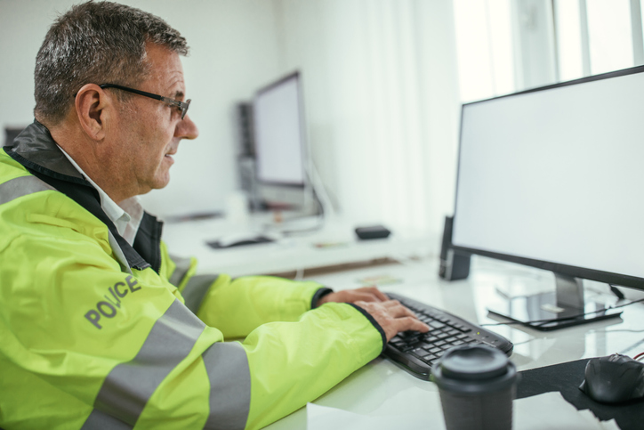 Policeman working on computer