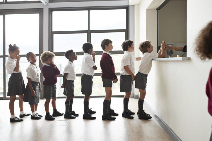 School children queuing for lunch in the canteen