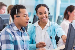 Confident IT manager trains new employee