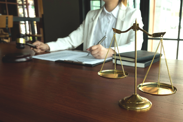 Midsection Of Lawyer Sitting On Table