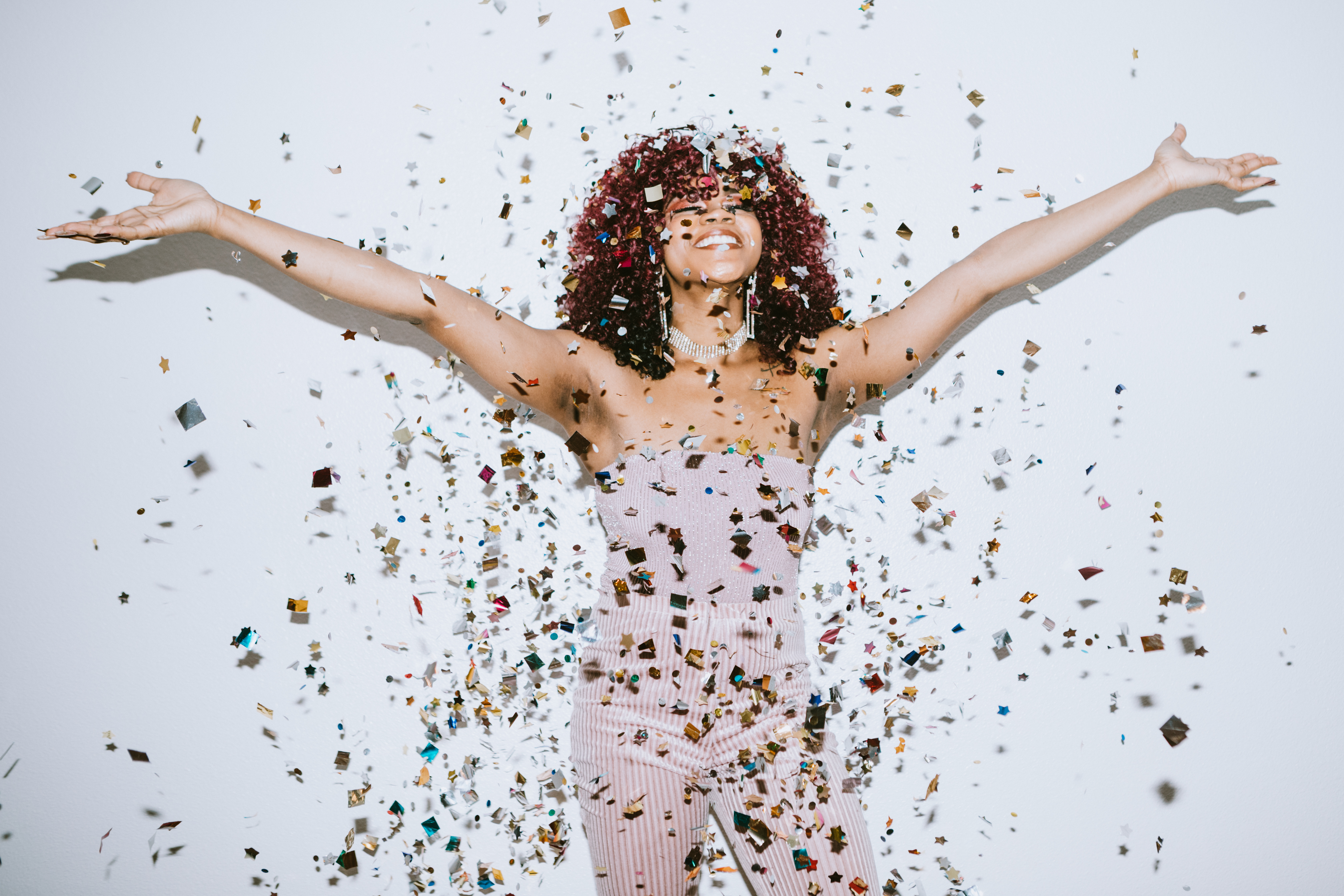 Generation Z Young Woman Celebrates With Confetti - stock photo
