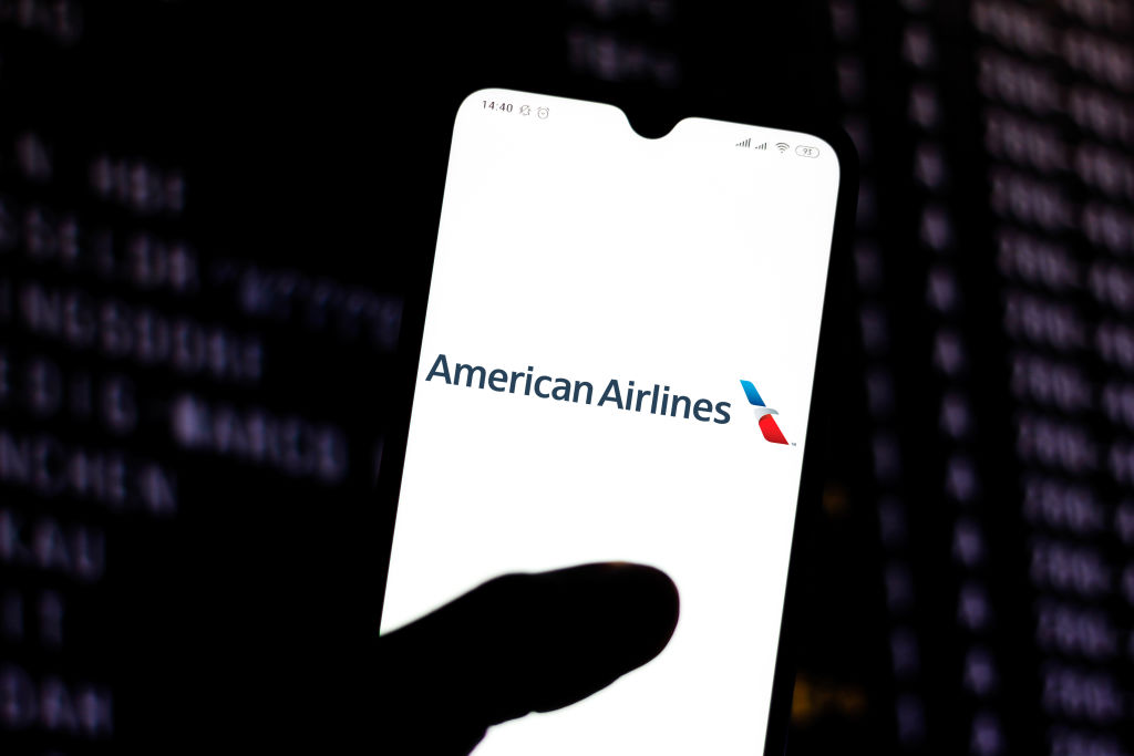 In this photo illustration the American Airlines logo is...