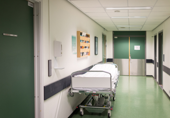 Bed in hospital corridor