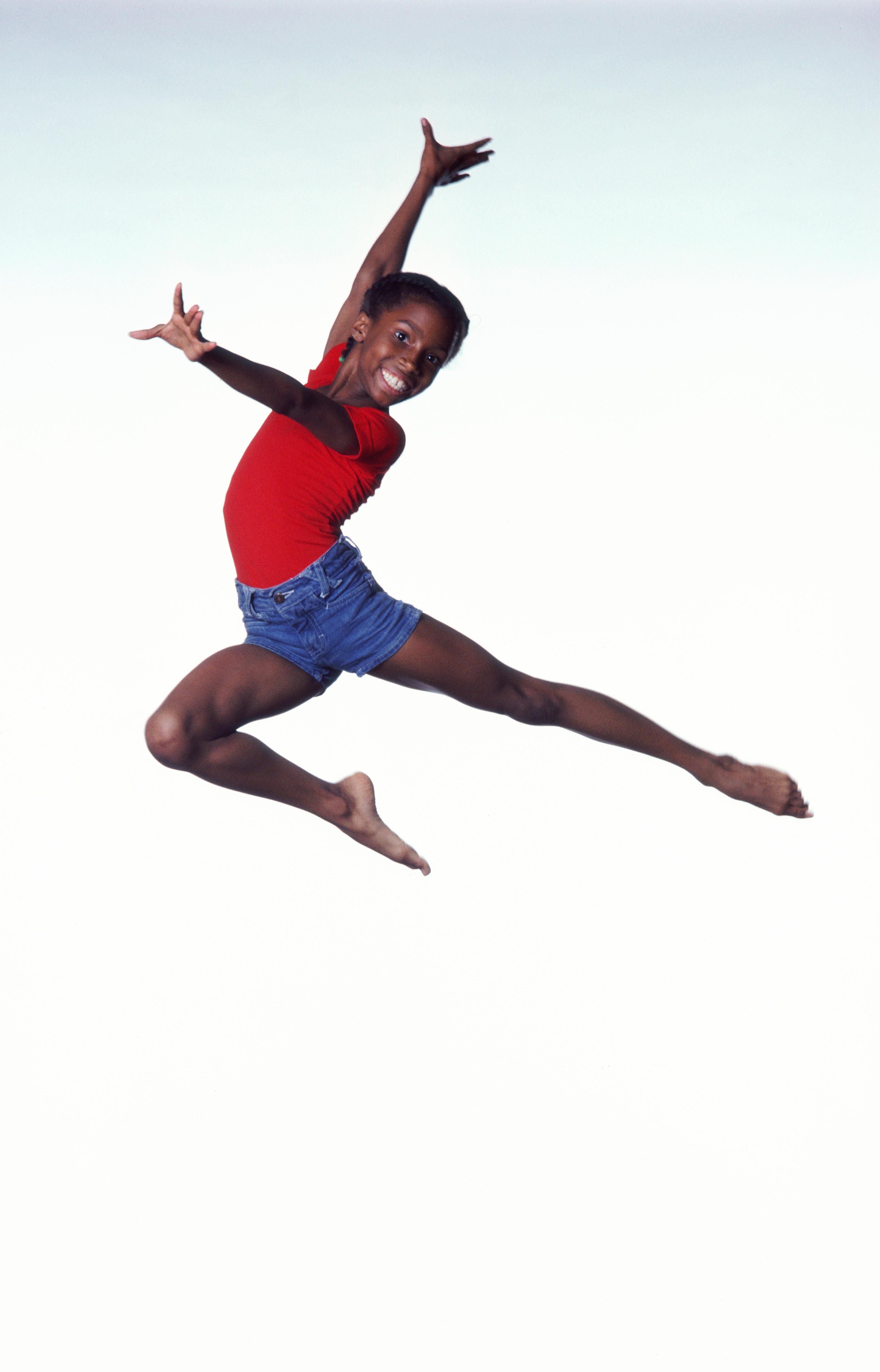 Girl (9-11) dancing in mid leap