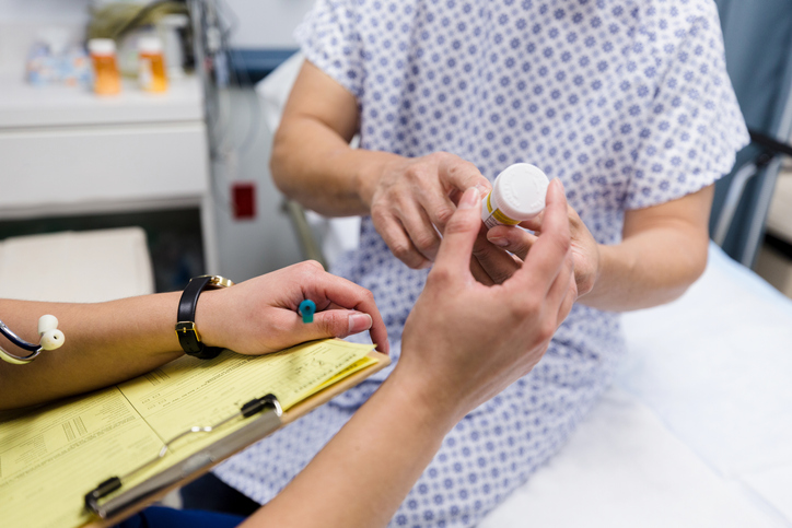 Unrecognizable man in hospital gown asks about medication