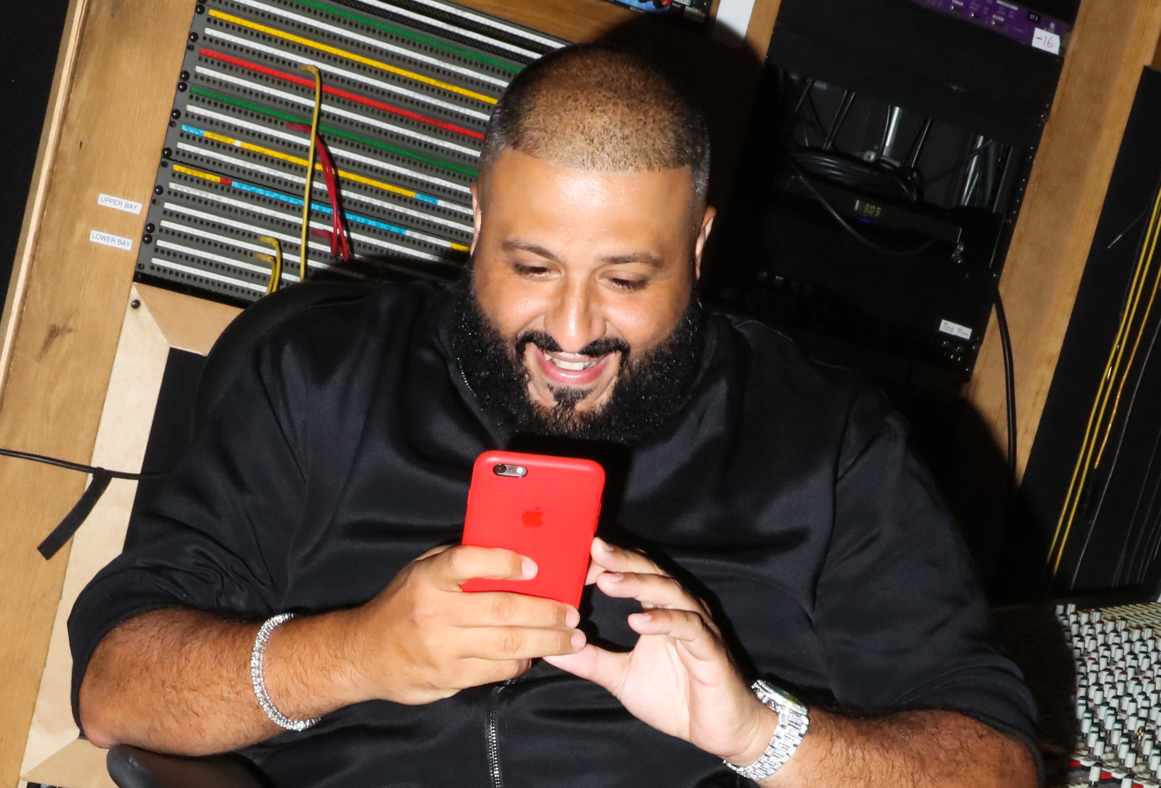 DJ Khaled posting a snapchat video with his phone at a private listening party for DJ Khaled's album Major Key, at Premiere Recording Studios