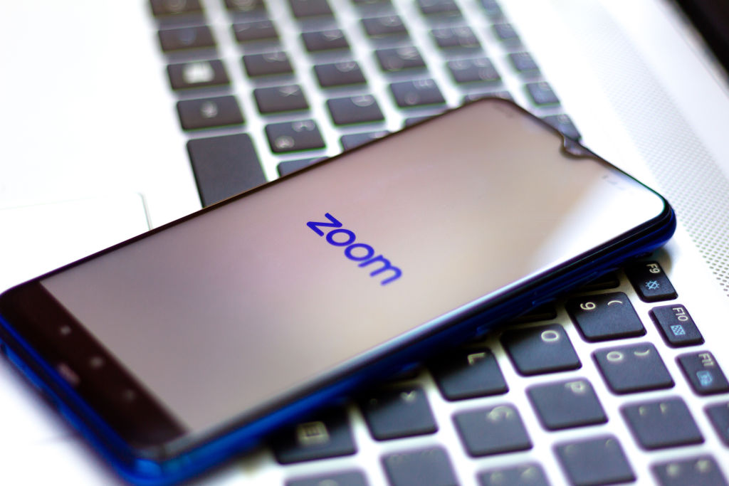 In this photo illustration a Zoom Video Communications logo...