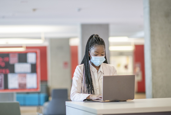 Young business woman wearing a mask