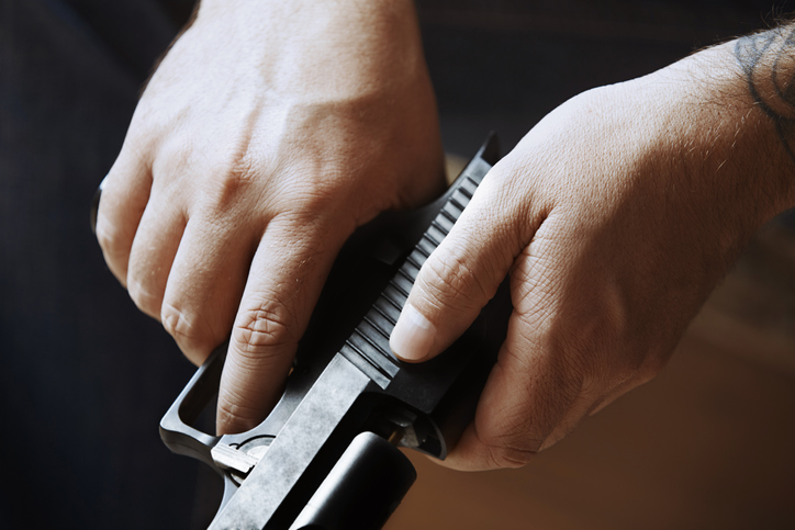 Hands of man holding handgun