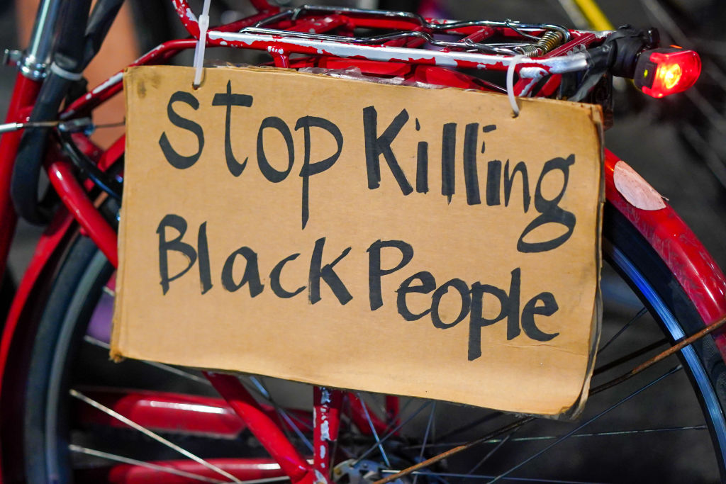 A 'Stop Killing Black People' placard seen on a bike during...
