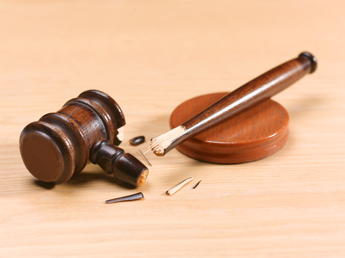 Broken gavel on desk