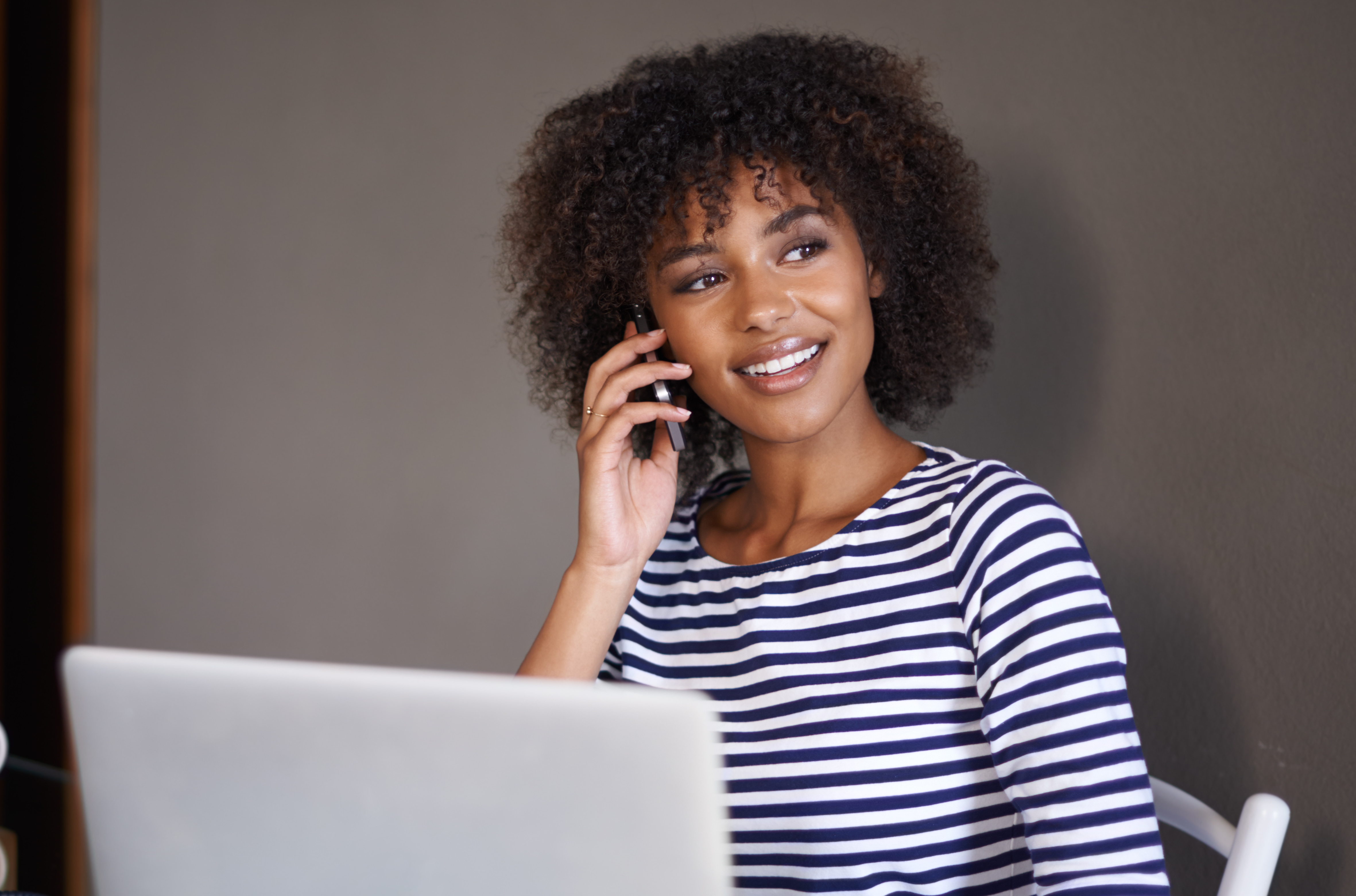Black woman taking business call