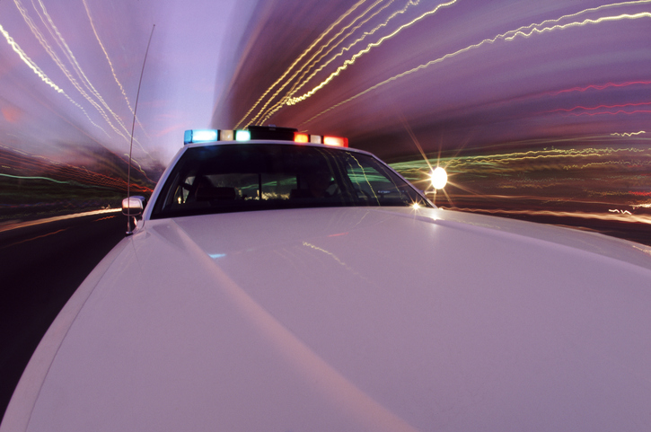 Squad car with siren blaring