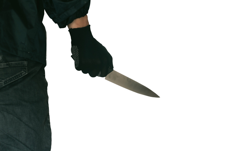 Midsection Of Man Holding Knife Against White Background