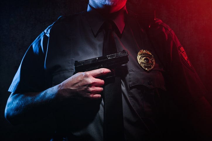 Police Officer Holding Gun