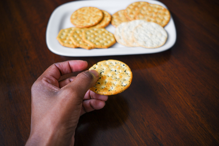 Woman Snacks on Crackers