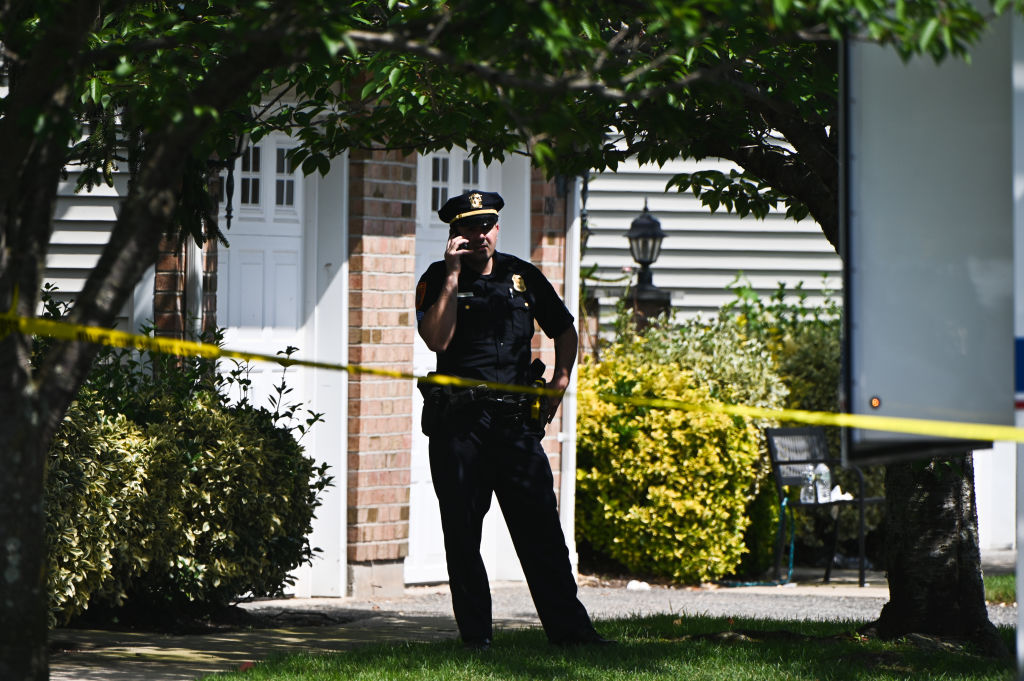 Suffolk County, New York policeman stands in front of crime scene on Long Island