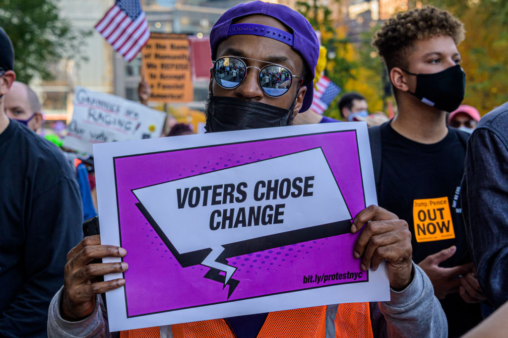 A participant holding a sign at the celebratory march.